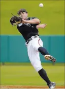  ?? PHELAN M. EBENHACK/ THE ASSOCIATED PRESS ?? Atlanta Braves shortstop Chase D’Arnaud throws to first base after fielding a grounder during a spring training workout on Saturday in Lake Buena Vista, Fla. D’Arnaud is one of baseball’s new super subs and is capable of manning any position except...