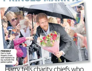  ??  ?? FRIENDLY Harry took flowers from well-wishers to lay outside the palace gates