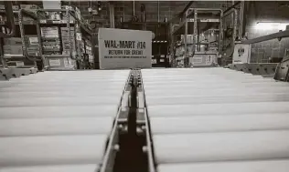  ?? Associated Press file photo ?? With more people shopping online, stores such as this Walmart in Houston are doing double duty as shipping centers to try to get gifts to doorsteps as fast as possible.