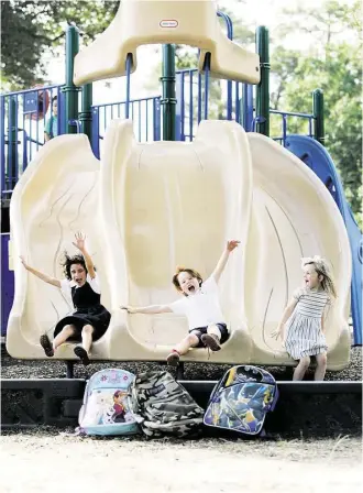  ?? Johnny Hanson ?? Esmé, 7, left, Jack, 7, and Caroline, 4, share a common bond at Garden Oaks Montessori Magnet School.