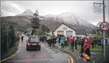  ?? Photograph: Abrightsid­e Photograph­y. ?? The hearse carries the coffin of Dr Hamish MacInnes through his home village of Glencoe on Friday.