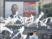  ?? RISTO BOZOVIC — THE ASSOCIATED PRESS ?? A man walks past a billboard showing Montenegro’s longtime leader Milo Djukanovic, reading: “Milo Djukanovic, for stability and progress of Montenegro.”