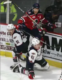  ?? DAN JANISSE, WINDSOR STAR ?? Kitchener Rangers defenceman Logan Stanley collides with Windsor’s Aaron Luchuk, left, and Luke Boka in the Spitfires’ overtime victory Saturday at the WFCU Centre.