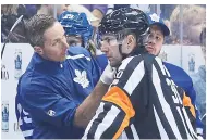  ?? STEVE RUSSELL TORONTO STAR ?? Referee Kendrick Nicholson is treated on the bench after getting hit in the face by a puck in Sunday’s game.