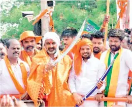  ?? — K. DURGA RAO ?? BJP state president Bandi Sanjay Kumar displays a sword during the 30th day of his Praja Sangrama Yatra in Maheshwara­m mandal on Friday.