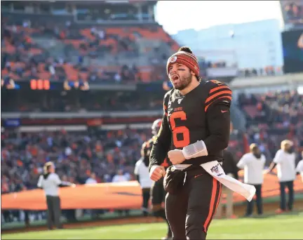  ?? TIM PHILLIS — FOR THE NEWS-HERALD ?? Baker Mayfield runs onto the field before the Browns faced the Ravens on Dec. 22.