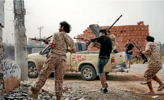  ?? WASHINGTON POST ?? Militia members clash on the Ain Zara front line in Tripoli, Libya.