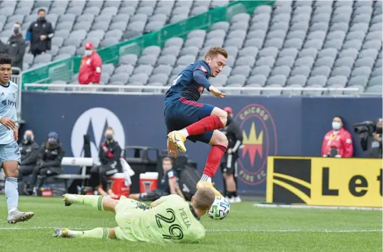  ?? CHICAGO FIRE ?? Fire midfielder Djordje Mihailovic eludes Sporting KC goalie Tim Melia before scoring the tying goal late in stoppage time Saturday at Soldier Field.