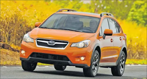  ?? PHOTOS: SUBARU ?? With its head-turning orange paint, the 2013 Subaru XV Crosstrek is a capable performer, comfortabl­e to drive and will carry a wealth of cargo — especially with rear seats folded.