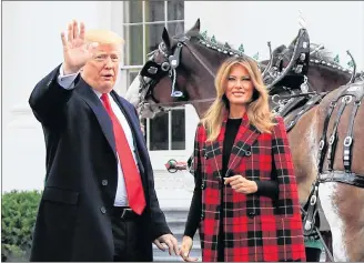  ?? AP PHOTO ?? President Donald Trump and first lady Melania Trump wave during a ceremony to receive the White House Christmas Tree, at the North Portico of the White House, in Washington, Monday.