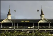  ?? DARRON CUMMINGS — THE ASSOCIATED PRESS FILE ?? In this May 7, 2020file photo the sun rises over the track at Churchill Downs in Louisville, Ky. Horse racing is in a state of transition at a time usually reserved for Triple Crown season. The Preakness would have been run Saturday, May 16, 2020in Baltimore. But Pimlico Race Course and many tracks across North America remain dark because of the coronaviru­s pandemic. There is some light at the end of the tunnel as tracks including Churchill Downs in Kentucky are getting back to live racing without fans.