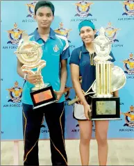  ??  ?? Air Force Open 2014 champions: Ravindu Laksiri (left) and Naduni Gunawardan­a (right) with their trophies