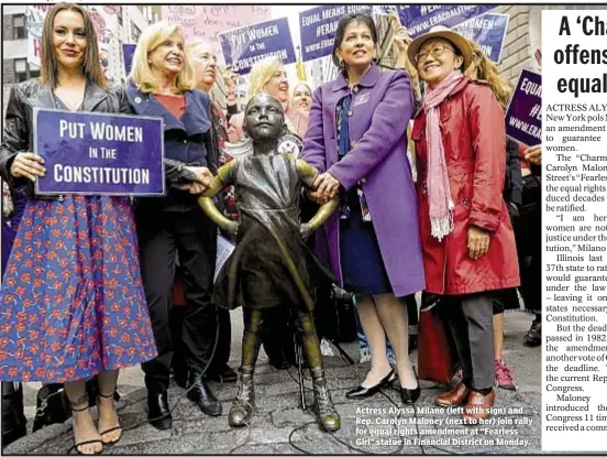  ??  ?? Actress Alyssa Milano (left with sign) and Rep. Carolyn Maloney (next to her) join rally for equal rights amendment at “Fearless Girl” statue in Financial District on Monday.