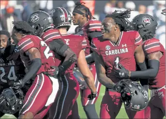  ?? AP ?? South Carolina defensive back Jaycee Horn (1) celebrates with teammates after defeating Auburn on Saturday in Columbia, S.C. South Carolina defeated Auburn, 30-22.