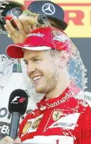  ??  ?? Doccia di champagne sul podio per Vettel