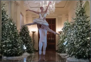  ?? AP Photo/Carolyn Kaster ?? Dancing ballerinas: A ballerina is lifted Monday during a performanc­e of a piece from The Nutcracker among the 2017 holiday decoration­s in the Cross Hall of the White House in Washington. First lady Melania Trump honored 200 years of holiday traditions at the White House with her chosen theme of “Time-Honored Traditions.”