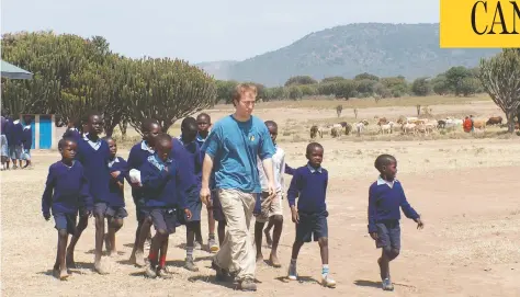  ?? SHELLEY PAGE FILE PHOTO ?? Craig Kielburger walks with Maasai students who attend a Kenyan school that was built by Kielburger’s charity Free the Children.