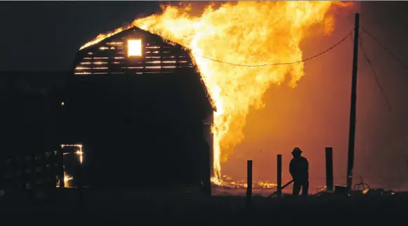  ?? GAVIN YOUNG ?? Grass fires swept across parts of Alberta on Oct. 17, 2017, destroying property near Airdrie, as seen here, at Gleichen, and in the far south community of Hilda.