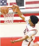  ?? BALTIMORE SUN KENNETH K. LAM/ ?? Spalding’s Cameron Whitmore dunks against Loyola Blakefield during the second quarter of a game Monday night.