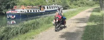  ??  ?? A bike on a towpath easily speeds past the hotel barge on the Burgundy Canal.