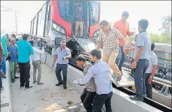  ?? . HT PHOTO ?? Passengers being evacuated through the emergency exit after the Metro train developed a snag