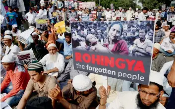  ?? — AFP file ?? indian demonstrat­ors hold placards as they take part in a protest against the treatment of rohingya in Myanmar.