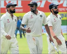 ?? Picture: AFP ?? PRICELESS: Ravichandr­an Ashwin, centre, talks with Murali Vijay, left, and Rohit Sharma after India’s Test victory over New Zealand.