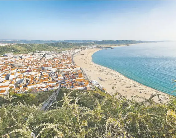  ?? DOMINIC ARIZONA BONUCCELLI/ RICK STEVES' EUROPE ?? Nazaré, two hours north of Lisbon in Portugal, hugs its wide beach on the Atlantic Ocean, waiting patiently for tourists to return.