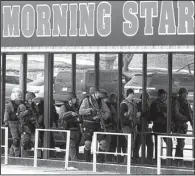  ?? The Sentinel-Record/RICHARD RASMUSSEN ?? Members of the Garland County sheriff’s tactical squad search a Cutter Morning Star School District building during a manhunt Friday.
