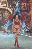  ?? PASCAL LE SEGRETAIN, GETTY IMAGES, FOR VICTORIA’S SECRET ?? Kendall Jenner takes flight in red boots and a long-line plunging bra.