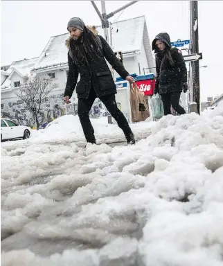  ?? ERROL McGIHON ?? Pedestrian­s make their way through the snow and slush along Elgin Street one day last month.