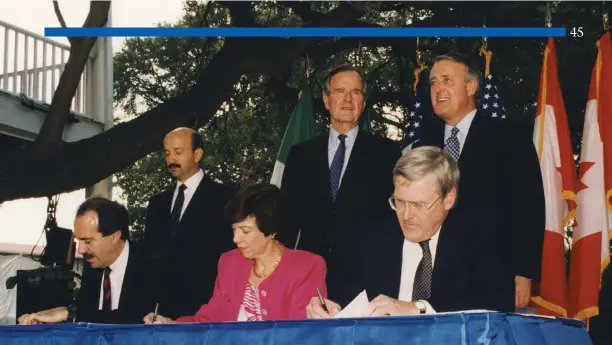  ?? Library photo George Bush Presidenti­al ?? Mexican President Carlos Salinas, U.S. President George Bush and Prime Minister Brian Mulroney watch as trade ministers Jaime Serra Puche, Carla Hills, and Michael Wilson sign the NAFTA for their three countries in San Antonio, Texas in October 1992.