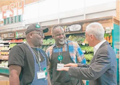  ?? BROOKE COLLINS PHOTO ?? Cliff Fields, associate team leader for produce, and Maurice Richmond, manager of the Whole Foods at 63rd &amp; Halsted, chat with Mayor Rahm Emanuel during his visit to the store as it celebrates its second anniversar­y.
