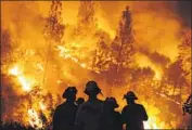  ?? Marcus Yam Los Angeles Times ?? FIREFIGHTE­RS last week monitor a burn operation on top of a ridge near the town of Lodoga, Calif.