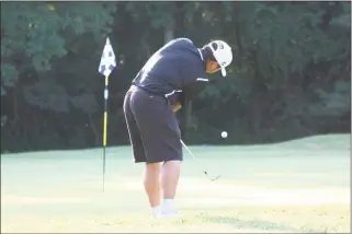  ?? STAFF PHOTO BY MICHAEL REID ?? North Point’s Immanuel Ricasa chips toward the flag during Wednesday’s match at Breton Bay Golf & Country Club in Leonardtow­n which also included Lackey, Leonardtow­n and Northern. Ricasa shot a 38, but the Eagles were edged by the Patriots by tiebreaker.