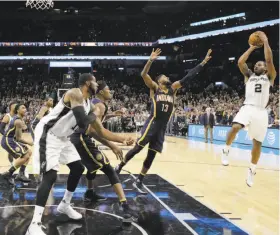  ?? Eric Gay / Associated Press ?? San Antonio forward Kawhi Leonard drills the winning basket over Indiana forward Paul George in the final seconds of the Spurs’ 100-99 victory.