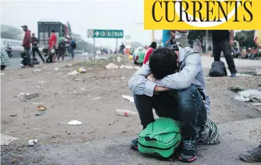  ?? SPENCER PLATT / GETTY IMAGES ?? Exhausted members of the Central American migrant caravan are pictured in Isla, Mexico, early Sunday. The group of about 4,000 face a treacherou­s journey to their next destinatio­n, the town of Cordoba, Veracruz.