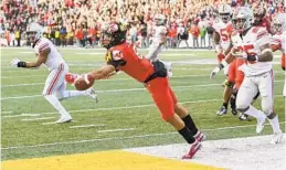  ?? JONATHAN NEWTON/THE WASHINGTON POST ?? A 2-point conversion pass attempt sails wide of Maryland wide receiver Jeshaun Jones in overtime Saturday, sealing the victory for Ohio State.