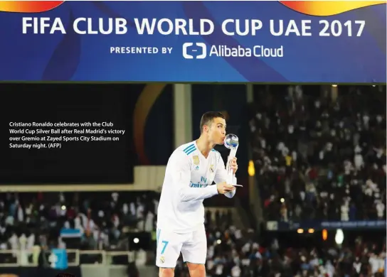  ??  ?? Cristiano Ronaldo celebrates with the Club World Cup Silver Ball after Real Madrid's victory over Gremio at Zayed Sports City Stadium on Saturday night. (AFP)
