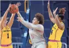  ?? CARLOS OSORIO/AP ?? Ohio State guard Kateri Poole has her shot deflected by Michigan guard Amy Dilk (1) on Sunday in Ann Arbor, Mich.