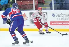  ?? JOE CSEH/SPECIAL TO POSTMEDIA NETWORK ?? St.Catharines Falcons forward Jacob Reeves, right, is defended by Patrick Desjardins of the Welland Junior Canadians. The Falcons wrap up the regular season tonight at home against the Ancaster Avalanche hoping to win their 10th in a row and 40th of...