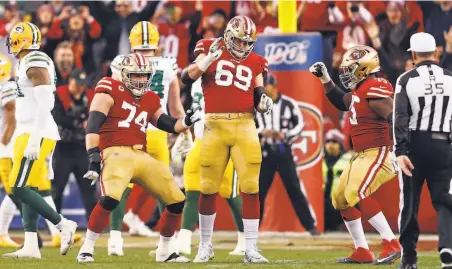  ?? Photos by Scott Strazzante / The Chronicle ?? Linemen Joe Staley (74), Mike McGlinchey (69) and Laken Tomlinson celebrate after Raheem Mostert’s third touchdown.