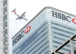  ??  ?? An aircraft flies past the HSBC headquarte­rs building in the Canary Wharf financial district in east London. — Reuters