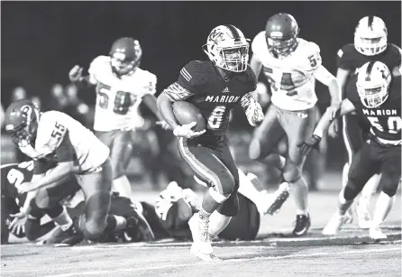  ?? STAFF PHOTOS BY ROBIN RUDD ?? Marion County’s Jacob Saylors (8) breaks loose for a big gain during the Warriors’ 47-13 victory over Polk County on Friday night in Jasper, Tenn. Saylors rushed for 231 yards and scored five touchdowns to help the Warriors secure Region 3-2A’s No. 2...