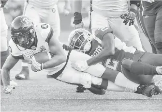  ??  ?? The Alouettes’ Dominique Ellis, right, tackles Ottawa’s Noel Thomas Jr. Friday night in Montreal.