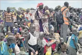  ?? SAM MEDNICK/AP ?? South Sudanese residents line up to be registered at a food distributi­on center last week in Old Fangak, in Jonglei state. Shortages have been reported for refugees in Uganda.