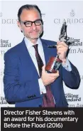  ??  ?? Director Fisher Stevens with an award for his documentar­y Before the Flood (2016)