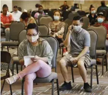  ??  ?? LOOKING FOR A JOB: People wait to speak with representa­tives from the Oklahoma Employment Security Commission about unemployme­nt claims on July 9 in Midwest City, Okla.