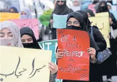  ??  ?? Women carry signs as they take part in a march demanding equal rights, ahead of Internatio­nal Women’s Day in Karachi on March 6 last year.