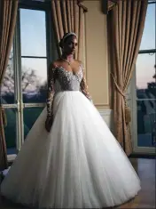  ?? ALONUKO VIA THE NEW YORK TIMES ?? A model shows a wedding gowns offered by Alonuko, which was founded by Gbemi Okunlola. After shopping with her sister for her wedding in 2014, Okunlola designed a sheer tulle for Black women.